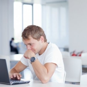 Leaning forward over the computer