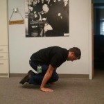Tuck planche hold on the floor. Take a few seconds and see how long you can hold or do some reps. Keep those arms straight! Alexander is in the background encouraging me.