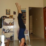Anywhere Workout Challenge - Headstand. Maria carefully gets into position with weight balanced on forearms and head evenly. Keep back straight and core engaged. Pic taken in Mochudi, Botswana. You really can workout anywhere!
